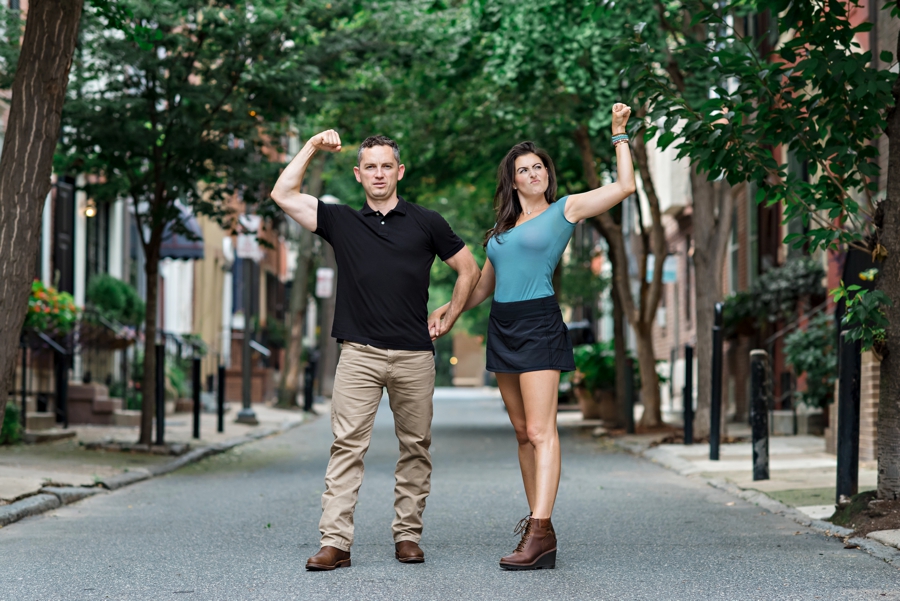 An engaged couple flex for the camera in Philadelphia.